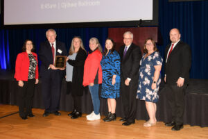 Photo of UW-River Falls’ Custodial Services receiving the Board of Regents 2022 University Staff Excellence Award in the program category. Accepting the award on the program’s behalf was Missy Davis, Custodial Supervisor for Facilities Management (3rd from left); Jackie Bennett, Custodial Supervisor for Residence Life (4th from left); Michelle Sponholz, Assistant Director for Residence Life-Facilities and Business Operations (2nd from right); and Alan Symicek, Executive Director of Facilities Management (far right). Also pictured (from left): UWRF Chancellor Maria Gallo, Regent Dana Wachs, Regent President Karen Walsh, and UW System President Jay Rothman.