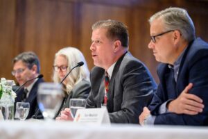 Photo of Dan Kelly, chief underwriting officer for American Family Insurance, second from right, speaking to the Board of Regents as part of a UW-Madison panel exploring university-business partnerships (Photo by Althea Dotzour / UW–Madison)