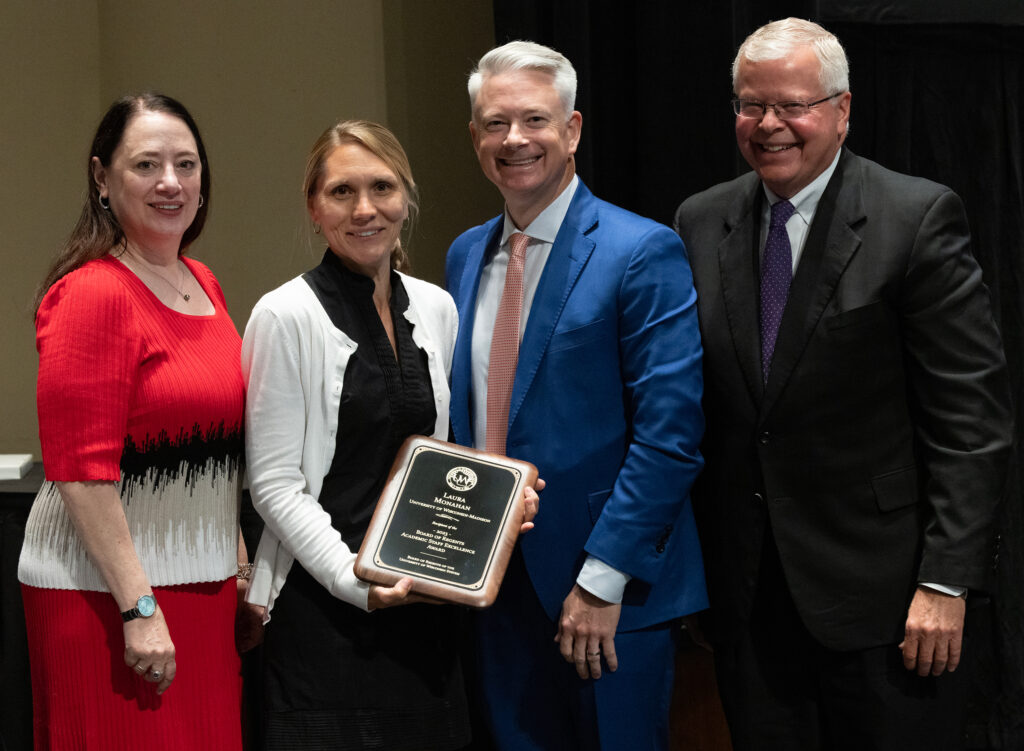 Photo of Laura Monahan, UW-Madison, receiving Board of Regents 2023 Academic Staff Excellence Award. Also pictured (from left): Regent President Karen Walsh, Regent John Miller, and UW System President Jay Rothman. (Photo by UWM)