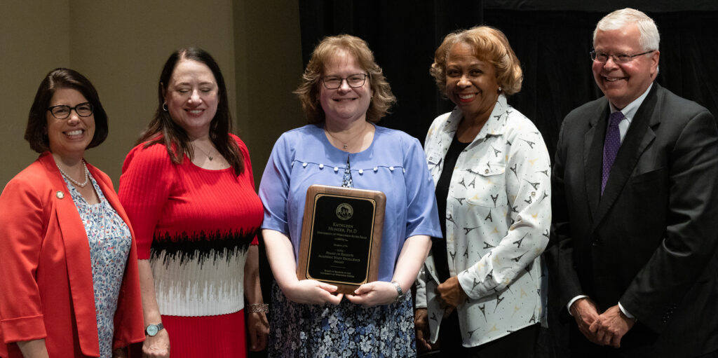 Photo of Kathleen Hunzer, UW-River Falls, receiving Board of Regents 2023 Academic Staff Excellence Award. Also pictured (from left): UW-River Falls Chancellor Maria Gallo, Regent President Karen Walsh, Regent Joan Prince, and UW System President Jay Rothman. (Photo by UWM)