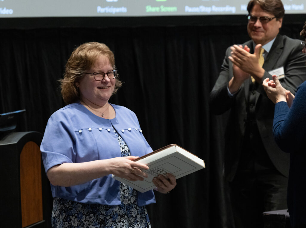 Photo of Kathleen Hunzer, UW-River Falls, accepting Board of Regents 2023 Academic Staff Excellence Award (Photo by UWM)