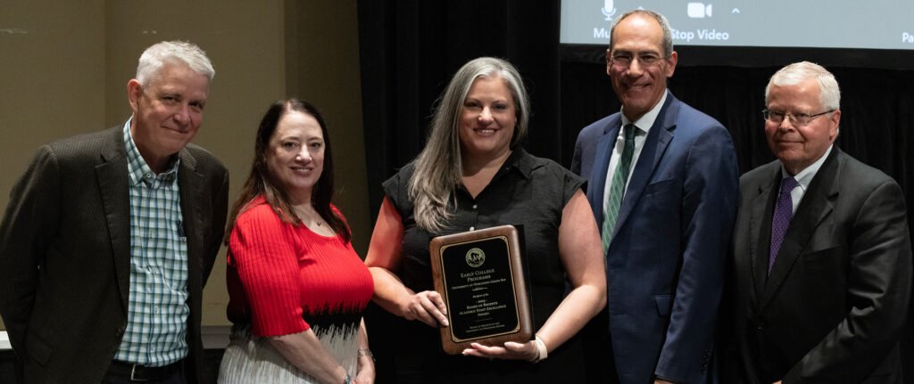 Photo: UW-Green Bay's Early College Programs received the Board of Regents 2023 Academic Staff Excellence Award, accepted by Meagan Strehlow (holding plaque) on behalf of the program. Also pictured (from left): Regent Bob Atwell, Regent President Karen Walsh, UW-Green Bay Chancellor Michael Alexander, and UW System President Jay Rothman. (Photo by UWM)