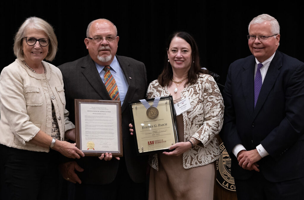 Photo of Regent Emeritus Rodney Pasch (second from left) accepting his resolution of appreciation for serving on the Board. Also pictured: (from left) Regent Cris Peterson, Regent President Karen Walsh, and UW System President Jay Rothman. (Photo by Jen Towner/UWL)