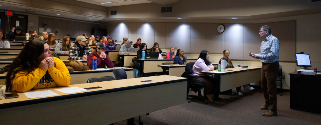 Photo of Rowand Robinson, right, professor of special education, teaching Special Education 201, Disability, Race and Ethnicity in Society, in Winther Hall on March 19, 2024. (UW-Whitewater photo/Craig Schreiner)