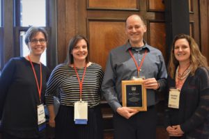 Wisconsin Teaching Fellows & Scholars 4 co-directors presenting a plaque to David Voelker, outgoing director.