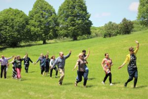 group running through grassy field