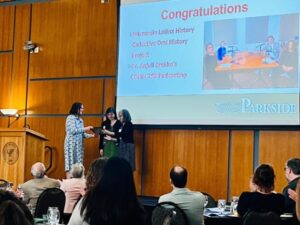 Photo of Anjuli Brekke accepting award.
