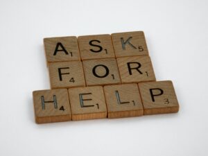 Scrabble tiles that say "ask for help"