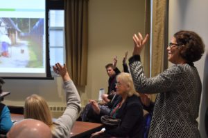 group raising their hands to ask questions