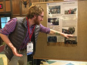 Student from UW-Platteville pointing to information on their poster