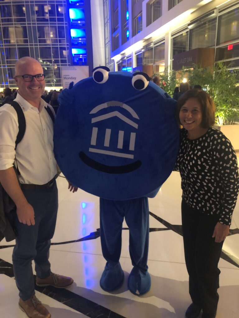John Gaffney of UW-La Crosse and Angela Kellogg of UW System with EAB Connected 19 conference mascot in lobby at Washington, D.C. hote.