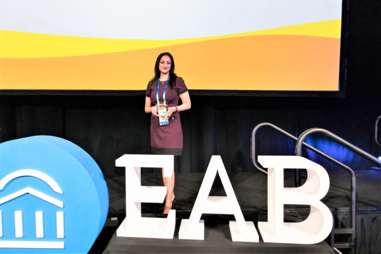 Pooja Agarwal of UW-Green Bay with EAB Award at EAB's Connected22 Conference in Orlando in November 2022
