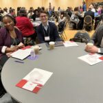 EAB reps at UW teams at table at UW System Navigate and Advising Workshop March 2023 at UW-Stevens Point include from left LaToya White, William Sogegian, Chase Vogel