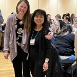 2 women standing together at UW System Navigate and Advising Workshop March 2023 at UW-Stevens Point