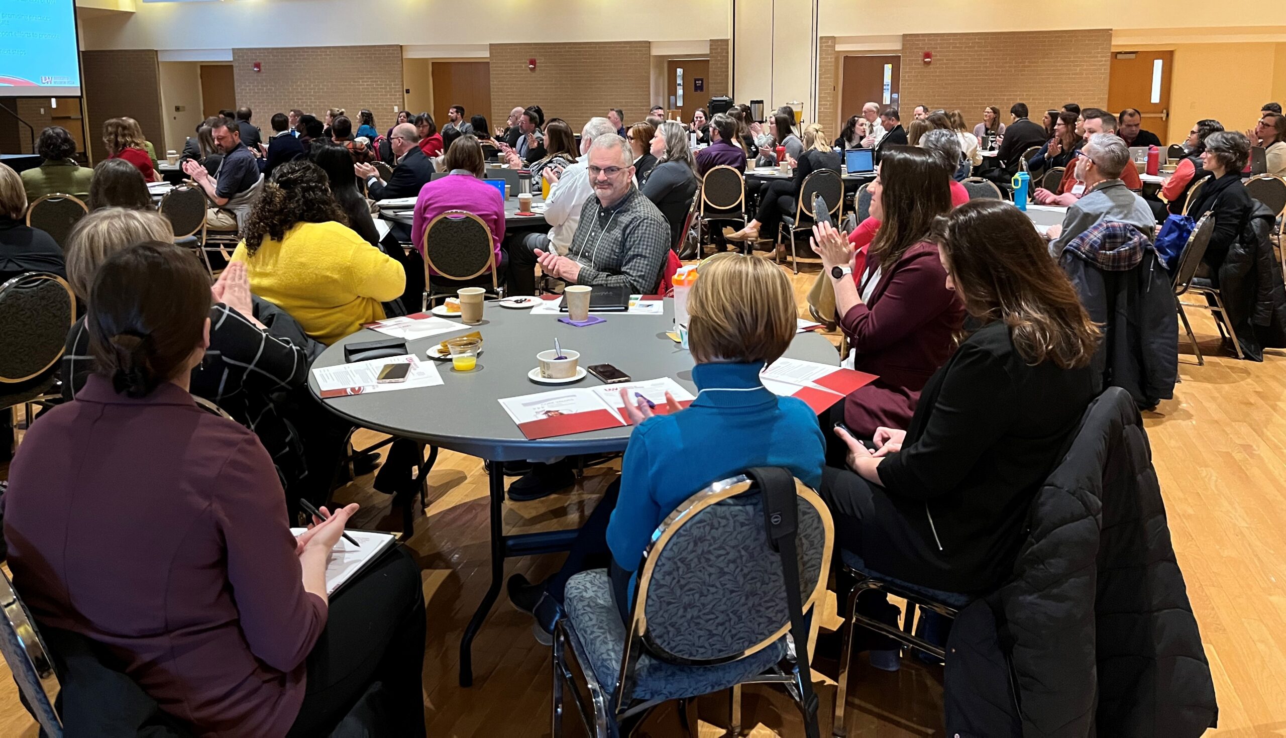 UW teams at tables at UW System Navigate and Advising Workshop March 2023 at UW-Stevens Point