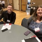 Matt Petersen of Northeast Wisconsin Technical College and Marie Smith of UW-Parkside seated at table at March 2023 workshop at UW-Stevens Point