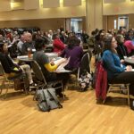 UW teams seated at tables at March 2023 workshop at UW-Stevens Point