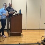 Billy Felz, left, and John Reichert, right, of UW-Eau Claire at podium presenting at March 2023 workshop at UW-Stevens Point