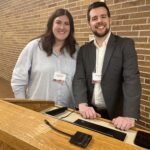 Megan Torkildson of UW-Superior and Justin Bruchey of EAB standing side by side at UW System Navigate and Advising Workshop March 2023 at UW-Stevens Point