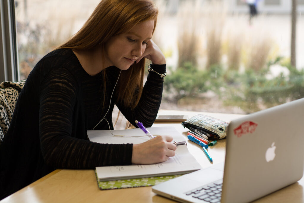 Photo of UW Oshkosh student with laptop