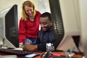 Student and teacher in computer lab