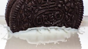 An Oreo being dunked in milk.