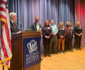 President Rothman presents awards during the 2023 UWSA Staff Awards ceremony on April 25. Several staff are on stage.