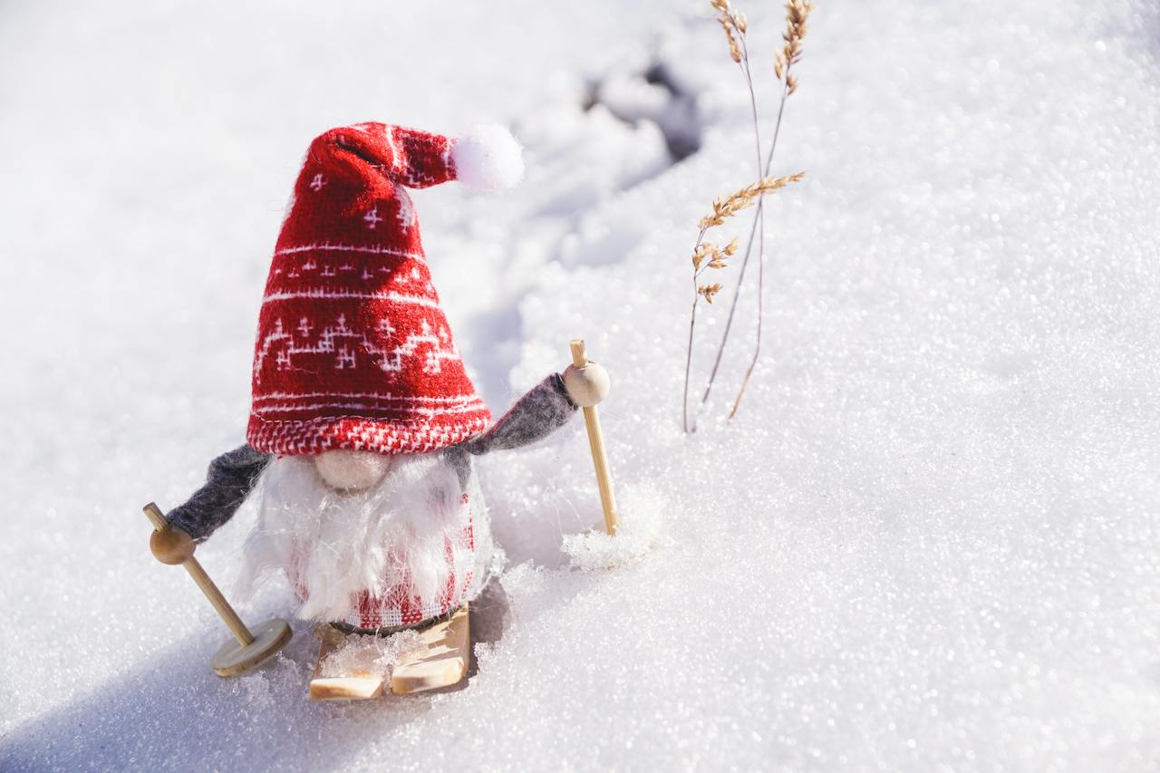 A gnome skiing through the winter snow. Photo by Susanne Jutzeler, suju-foto via Pexels.