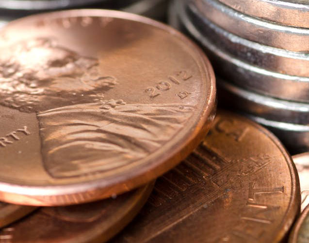 A stack of pennies and other coins. Photo by Jason Deines from Pexels.